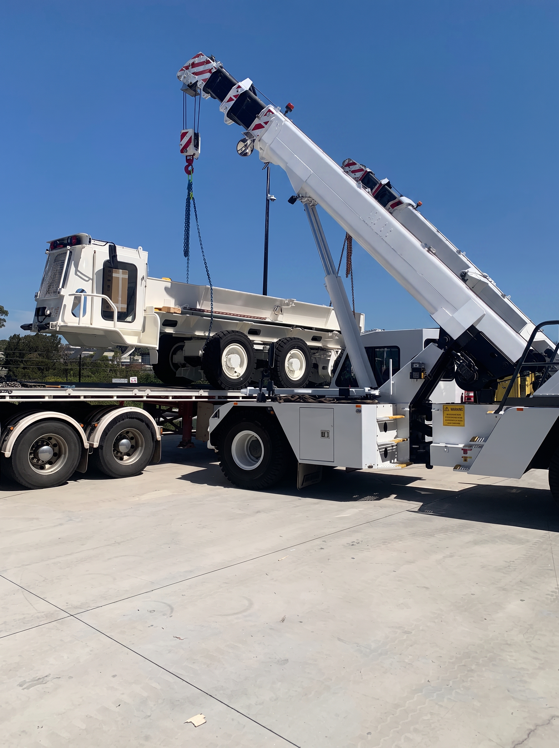 Solid Crane Hire's white 25 tonne Franna pick and carry crane in Sydney